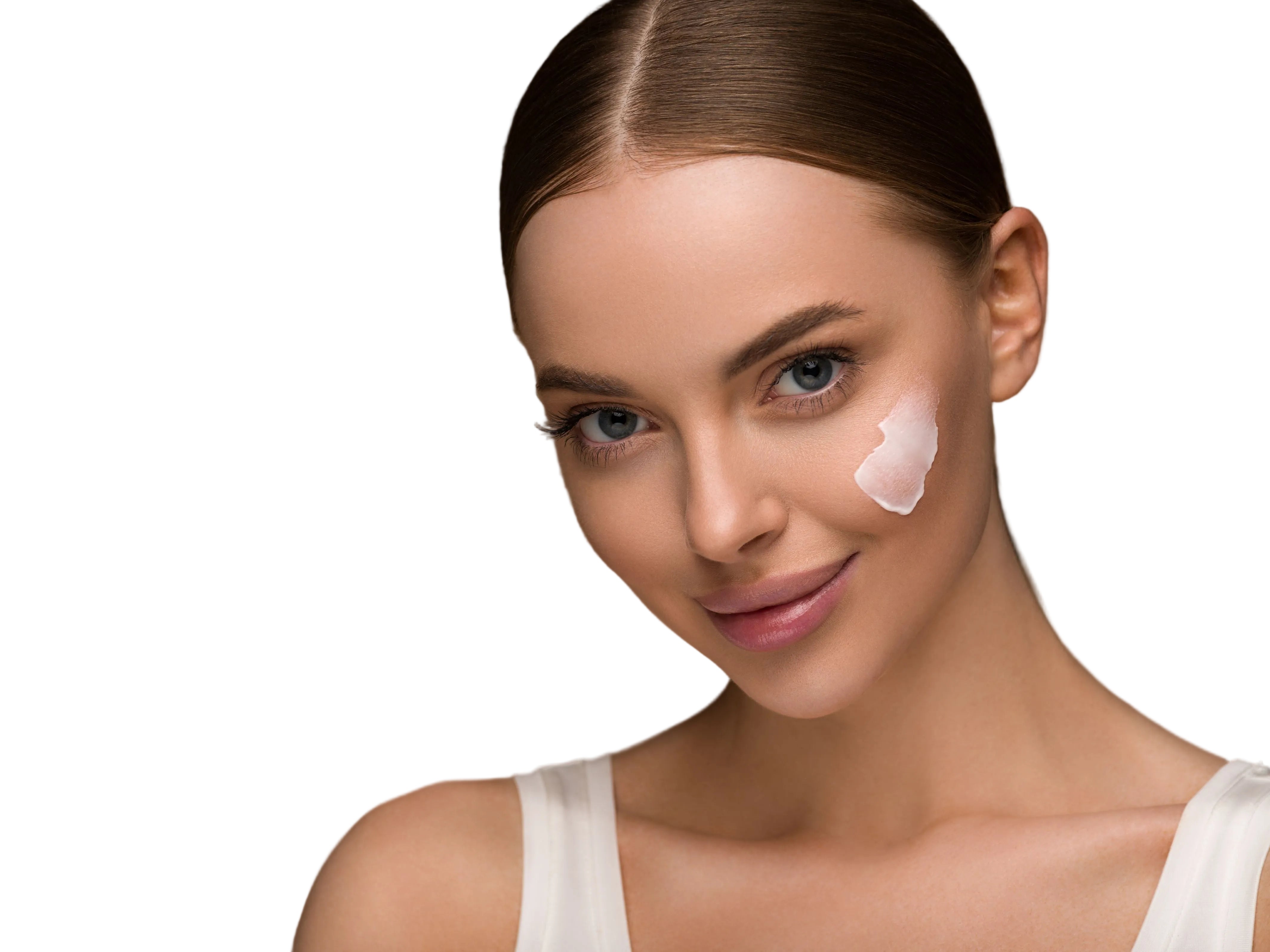 Woman with a face cream on her face against a white background