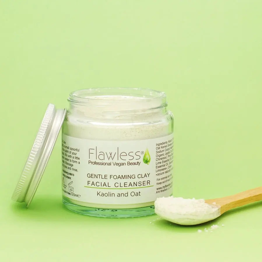 Jar of Flawless Gentle Foaming Clay Facial Cleanser on a green background