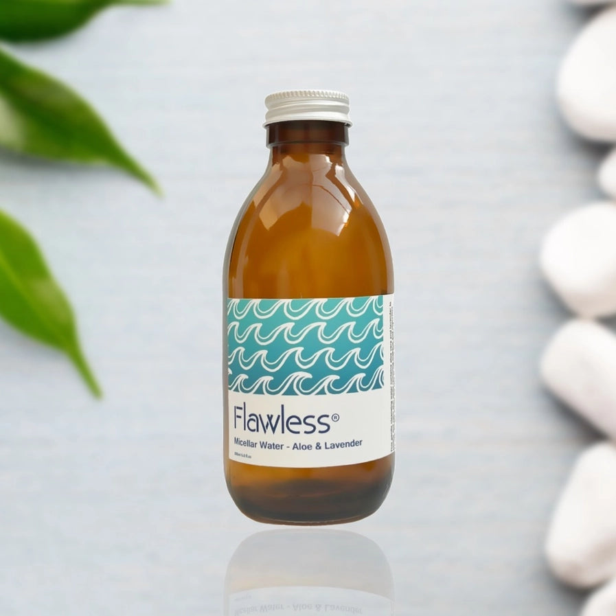 Brown bottle with a white label featuring the brand 'Flawless' on a patterned background