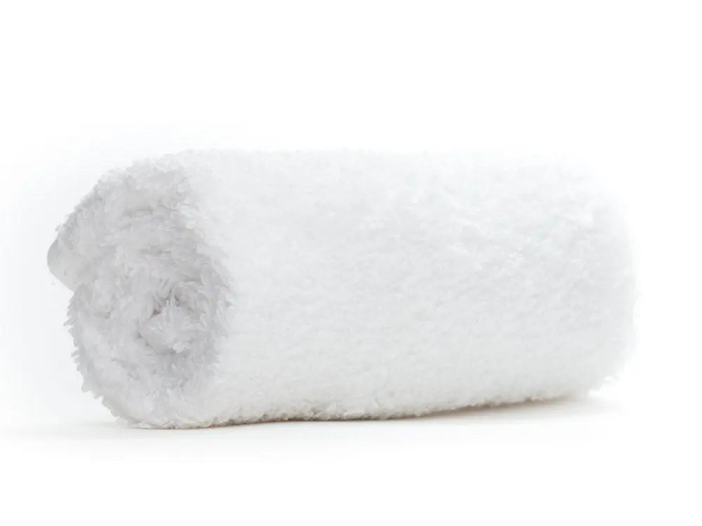 Folded white towel on a white background
