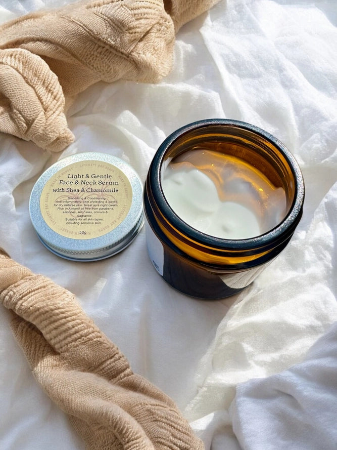 Jar of face serum and face towel on a white fabric background