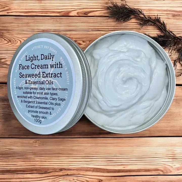 Open tin of light daily face cream with seaweed extract and essential oils on a wooden surface