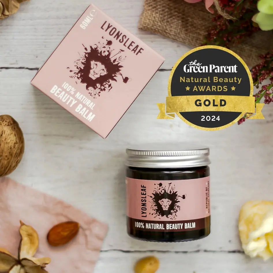 Lyonsleaf natural beauty balm jar with pink label on a rustic background, featuring The Green Parent Natural Beauty Awards gold badge.