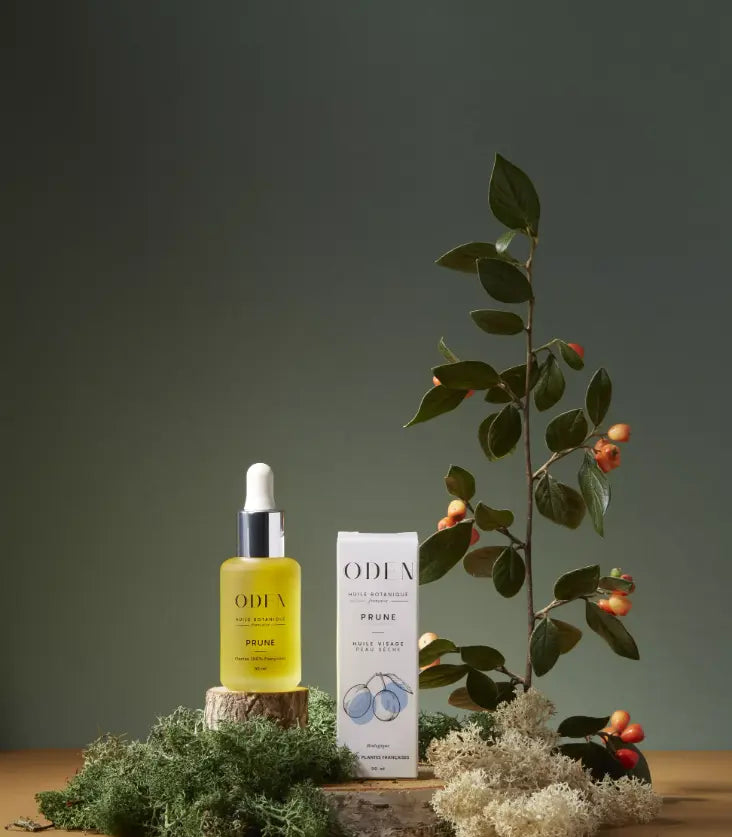 ODEN skincare product with packaging and a plant on a wooden surface