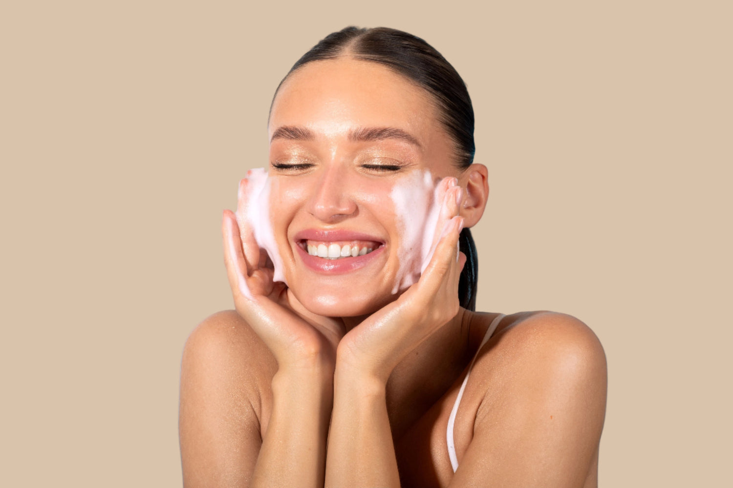 Girl cleansing her face smiling, blue background