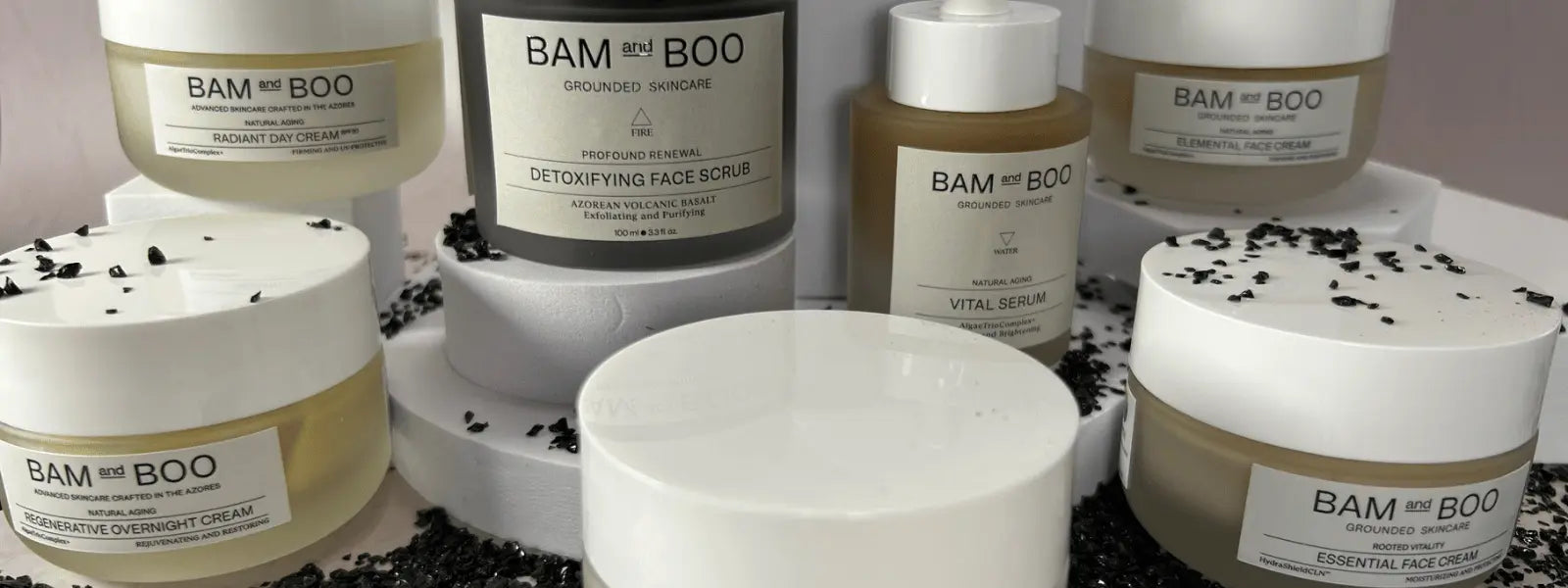 Bam and Boo banner image of bam and boo skincare products on a white background and black stones on the bottom.