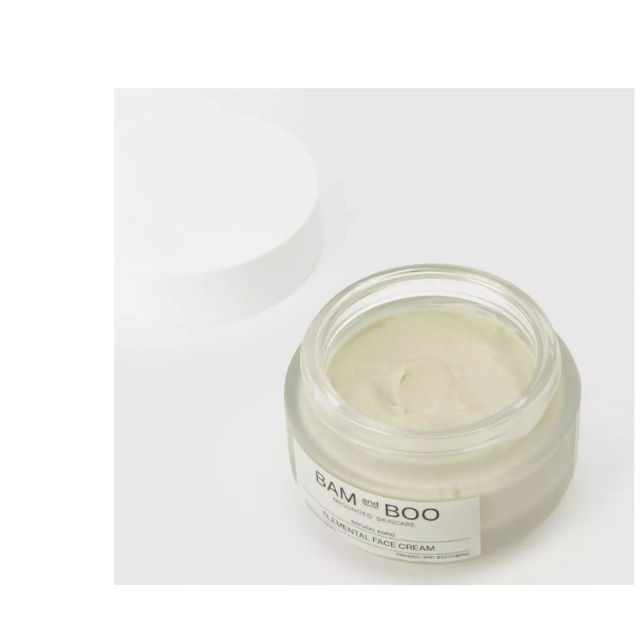 Jar of face cream with a white label on a light gray background