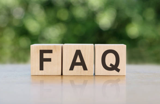 Wooden blocks with letters forming 'FAQ' on a blurred green background
