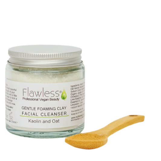 Jar of Flawless Gentle Foaming Clay Facial Cleanser with a wooden spoon on a white background