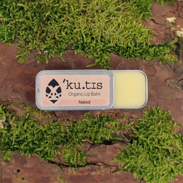 'ku.tis' organic lip balm on a natural background with moss, front open