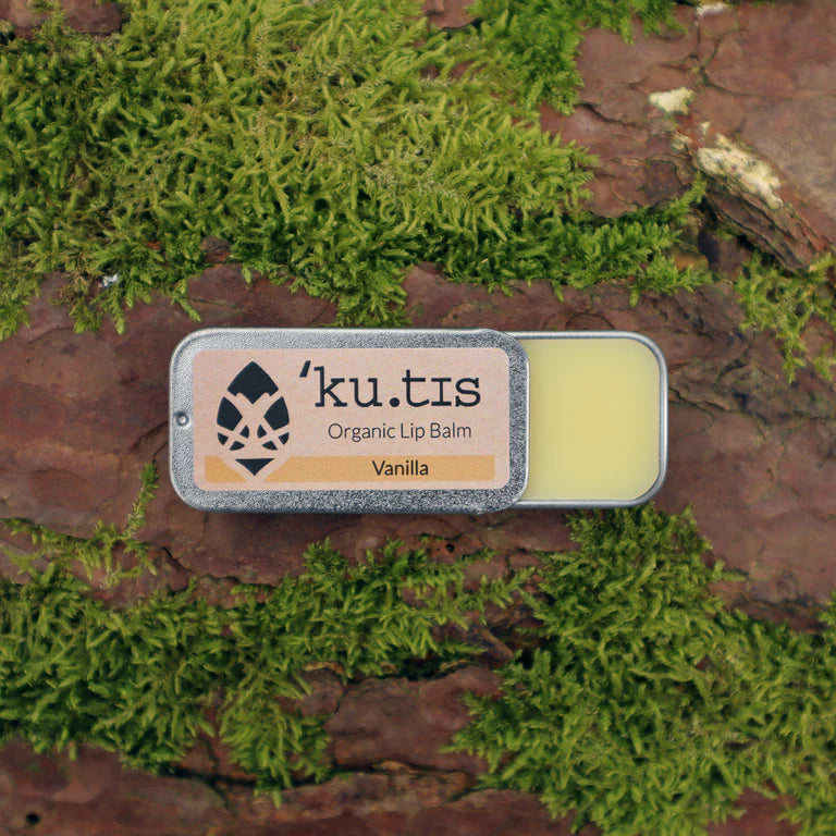 Kutis Vanilla Lip Balm, lid open, front, on moss background