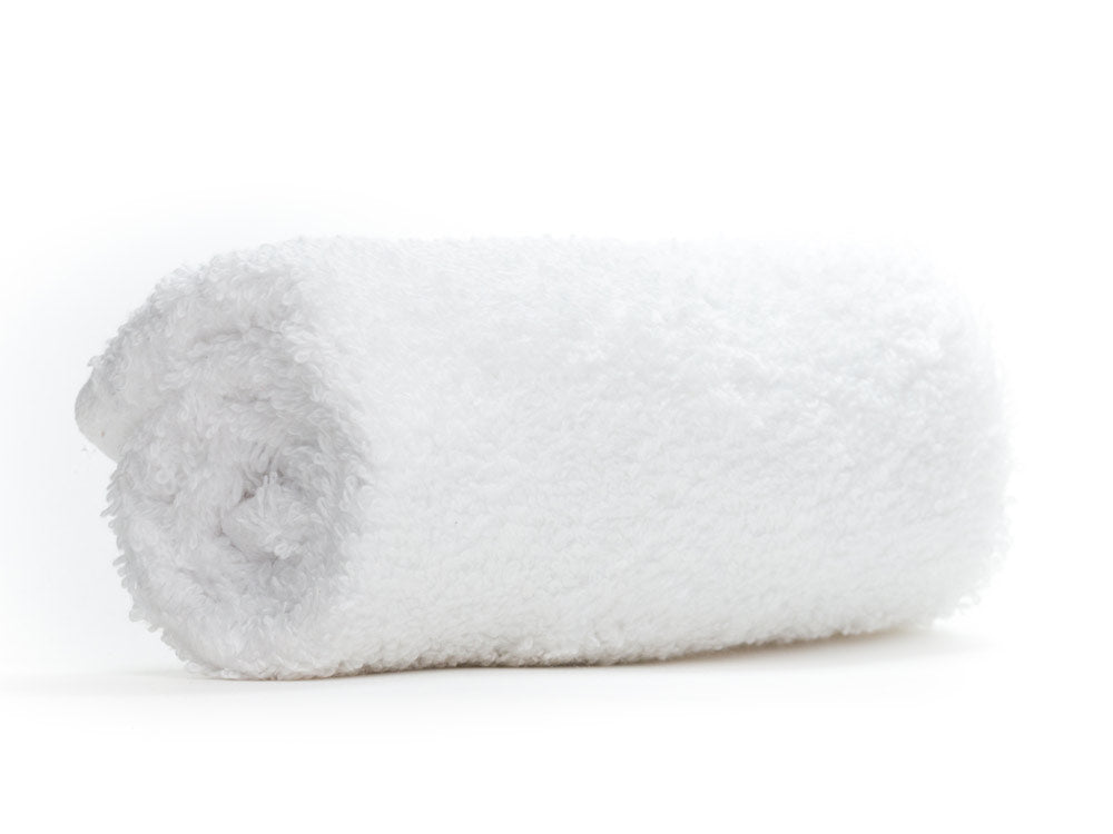 Folded white towel on a white background