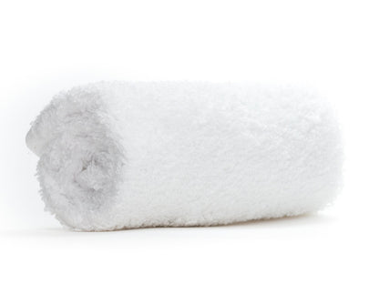Folded white towel on a white background