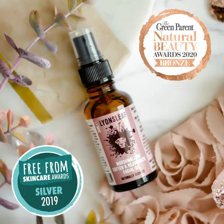 Brown bottle with pink label on a decorative background with awards badges.