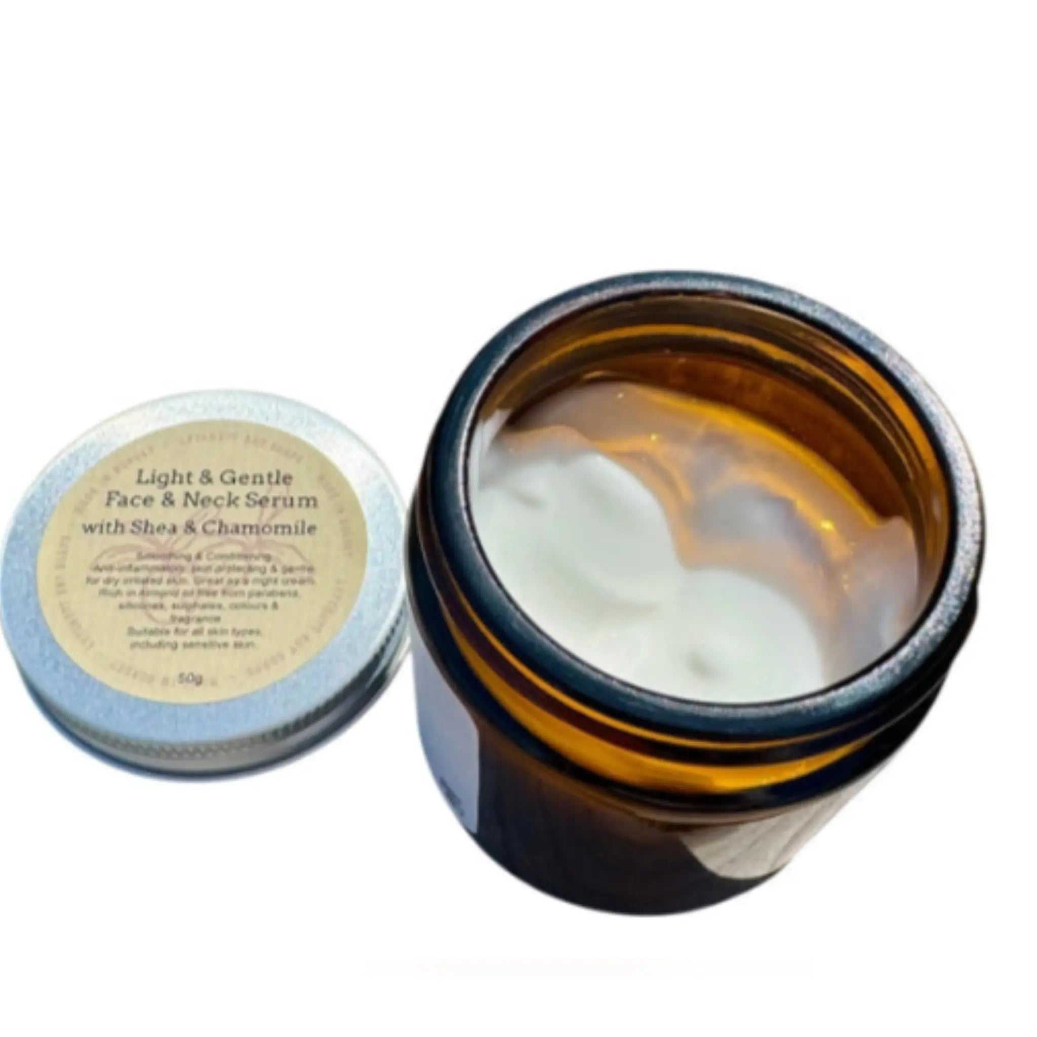 Lytchett bay soaps Open amber glass jar with face serum and round container labeled 'Light & Gentle Face & Neck Serum' on a white background.
