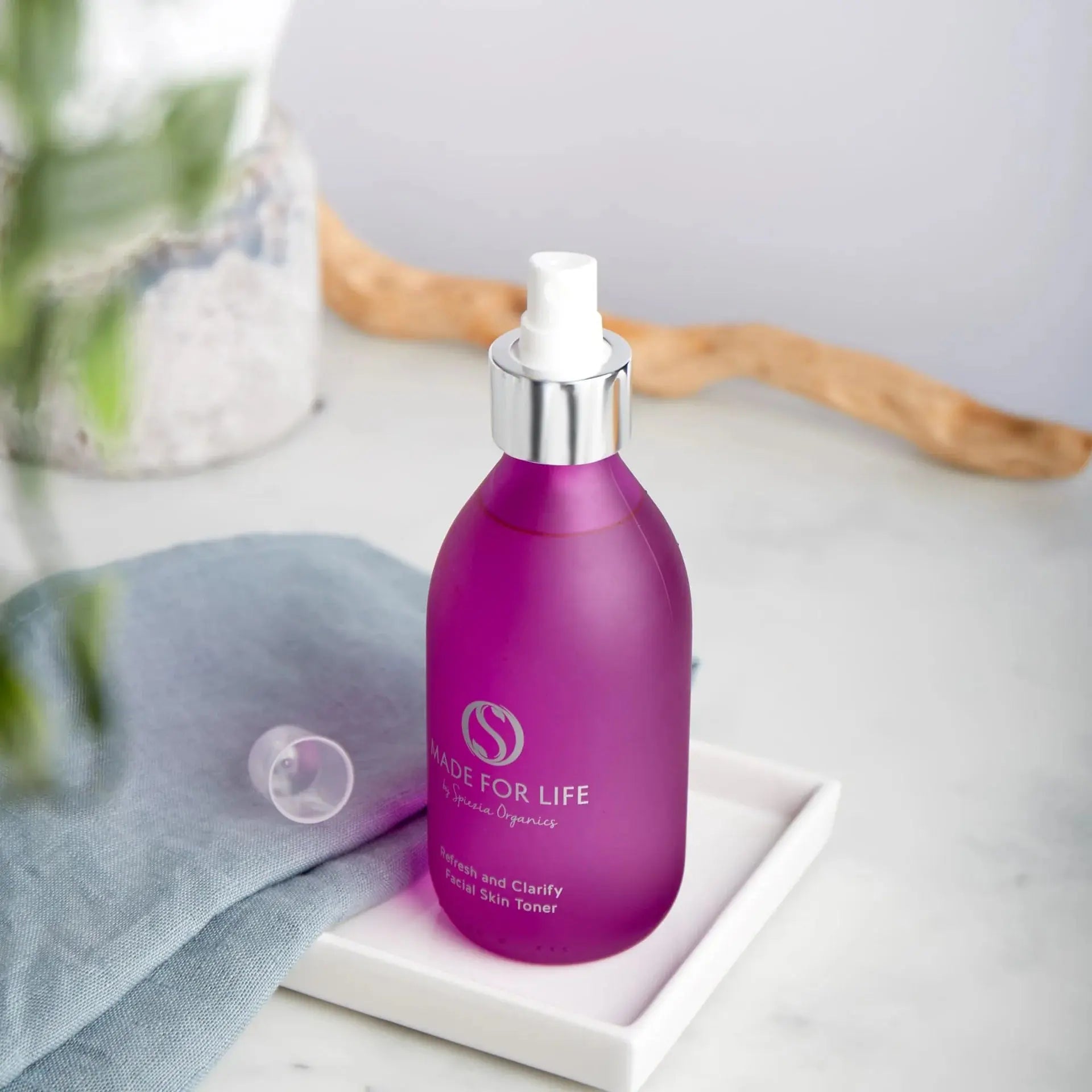 Made for life by Spiezia Refresh and Clarify Facia Skin Toner 250ml on white desk and blue cloth on a white tray. Front side view.