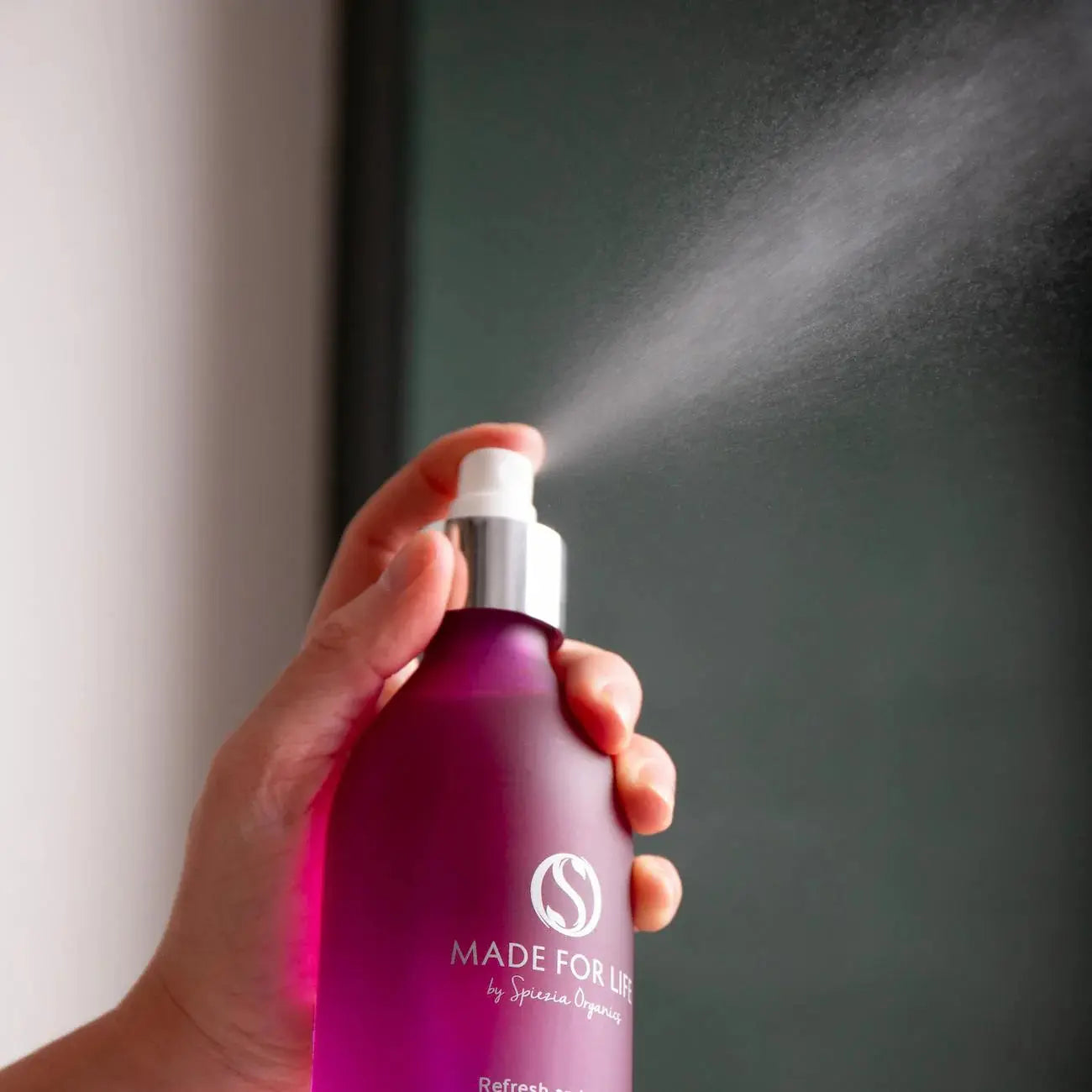 Made For Life by Spiezia Refresh and Clarify Face Toner 250ml, hand spraying mist on green background.