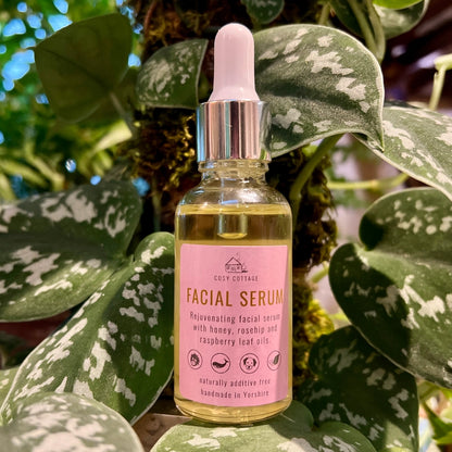 Natural serum with honey, Rosehip, Raspberry leaf oil, front, background plants