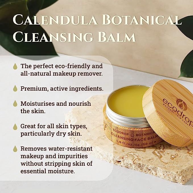 ecodrop Calendula botanical cleansing balm with wooden lid on a stone surface, surrounded by green leaves.